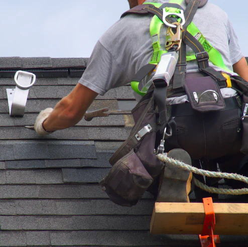 close up shot worker replacing new asphalt shingles